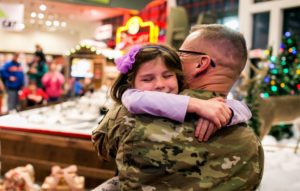 Len Cowitch who has been deployed since January 7, 2016 and has seen his daughter Isabella ,7, and wife Angela only once in the last 12 months, surprises them at Bass Pro Shops as Isabella has her picture taken with Santa. December 06, 2016 | Sean Simmers