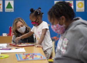 Aimee Dunn, left, who owns Clubhouse Kids with her husband Chris Dunn, works with the newly-opened childcare center’s first two enrollees Monday. Staff photo by Graham Cullen