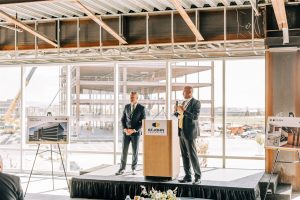 Scott Gifford, leasing representative for St. John Properties, and Daniel Thomas, regional partner for St. John Properties, speak at the groundbreaking of Valley Grove III on Tuesday, Sept. 27, 2022.