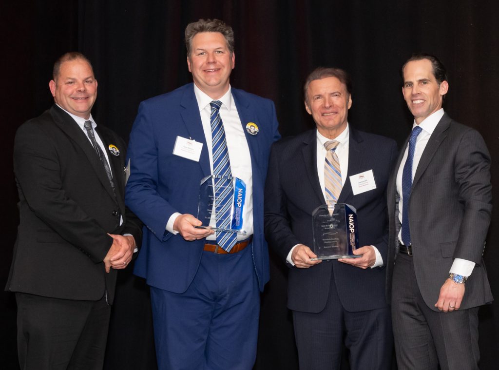 Representatives from St. John Properties and Rosedale Roofing accepting the Best Build-to-Suit Warehouse award for the Rosedale Roofing Headquarters at the 2026 NAIOP Maryland Awards of Excellence